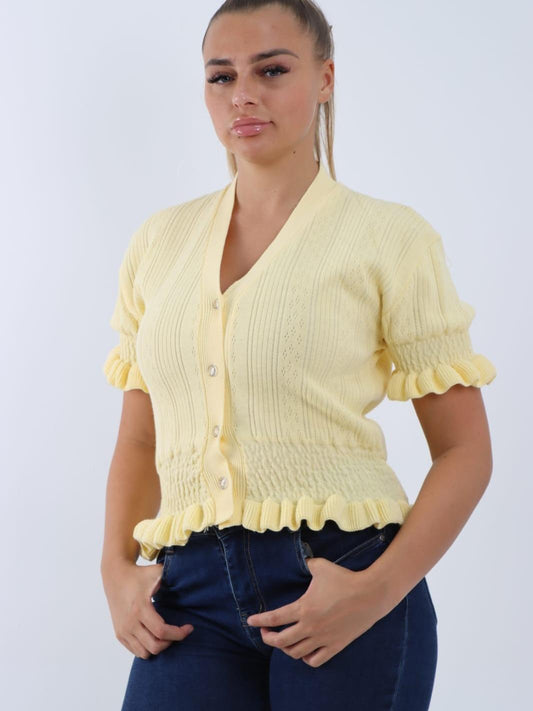 Short-sleeved, V-neck, button-down knitted cardigan with ruffle details.