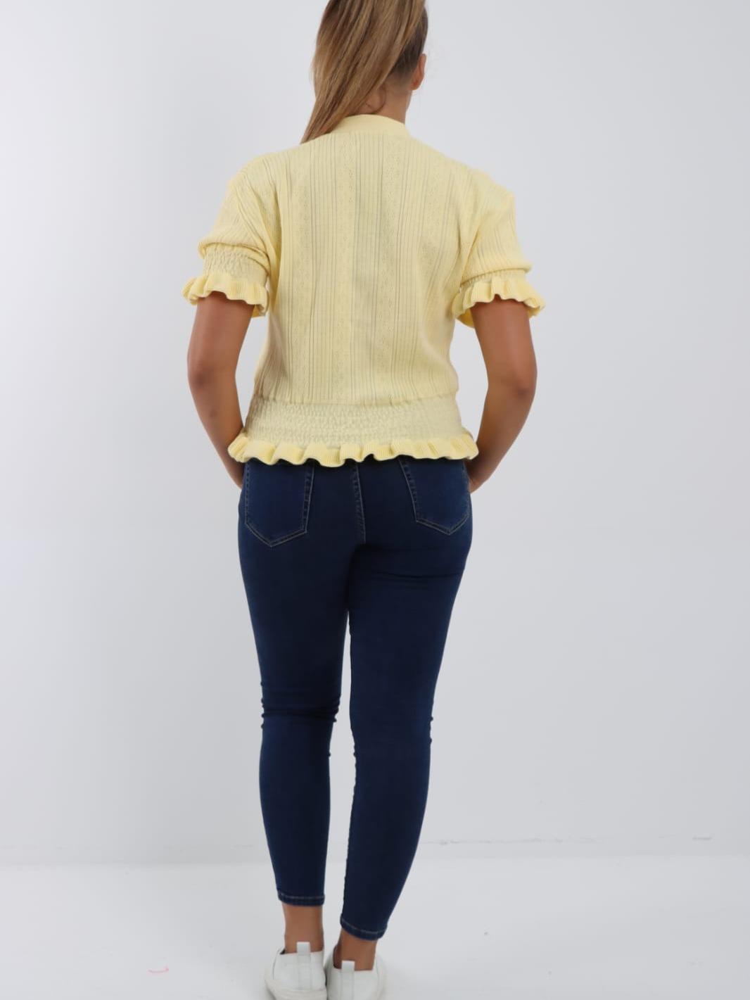 Short-sleeved, V-neck, button-down knitted cardigan with ruffle details.